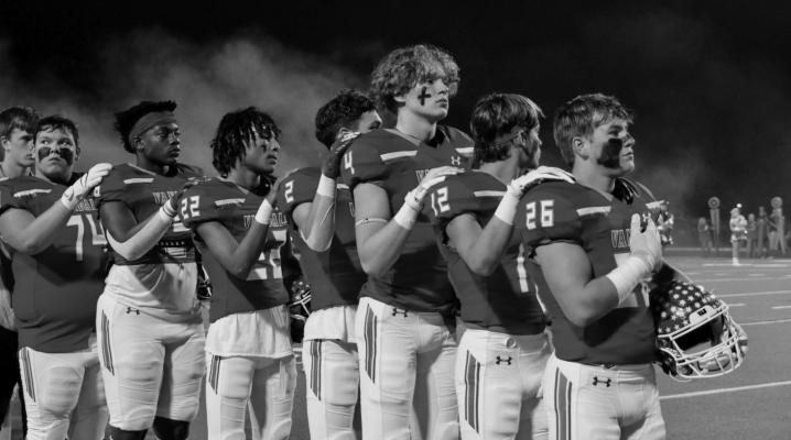 Van Vandal varsity football players prepare to stand at attention for the playing of the National Anthem prior to the start of their football game at Van’s Memorial Stadium Oct. 22. Photos by Elizabeth Meyers