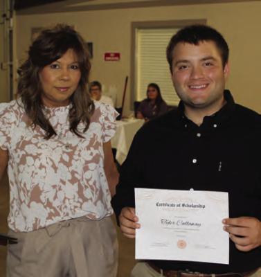 Tyler Calloway of Fruitvale was named as the winner of a $500 graduation scholarship from the Grand Saline Chamber of Commerce. Presenting the scholarship was Grand Saline Chamber of Commerce Director Mary Corrales.