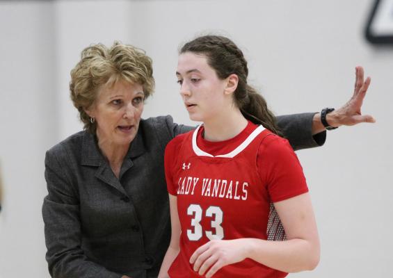 Coach Kay Bachert delivers instructions to sophomore post Shelby Burns during Van’s 49-47 win over rival Lindale Jan. 27. Burns would finish play with nine points and six rebounds. Photo by Liz Hinch