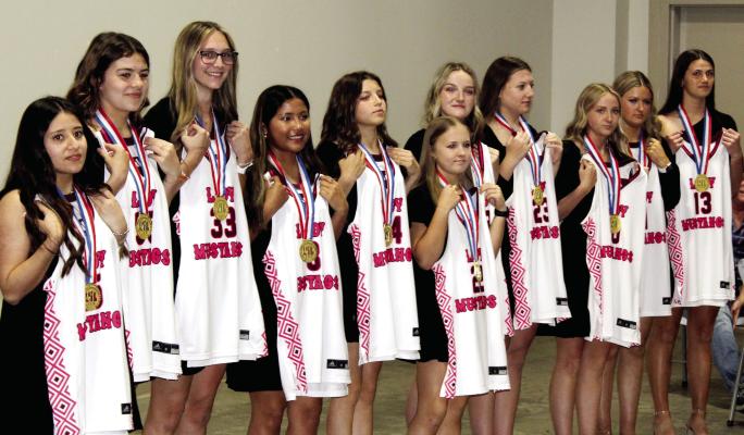 At the conclusion of the Martins Mill Lady Mustang Class 2A State Basketball Championship Banquet April 7, members of the team showed their game jerseys and the Gold medals that they earned after winning the state championship game March 2 in San Antonio. The banquet was held in the Van Zandt County Farm Bureau Event Center in Canton. Photo by David Barber