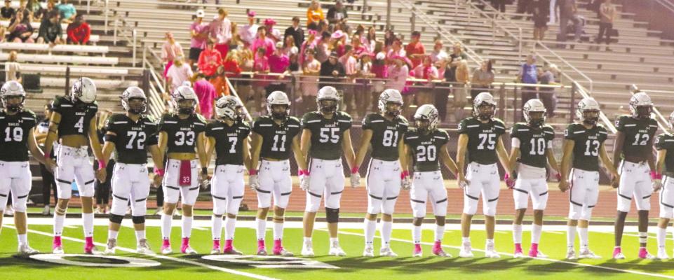 Canton players and coaches stand shoulder to shoulder prior to the coin toss ahead of play against Bullard. Photo by Lianna Reid