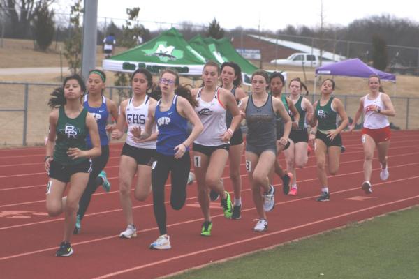 Hallie Lovvorn, at right, finished seventh overall in the 800 meter run while teammate Stephanie Mireles, at left, finished 10th overall at the Farmersville Farmer Relays. Photo by Jyllian Phillips