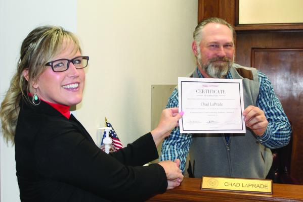 Van Zandt County Pct. 1 Commissioner Chad LaPrade was presented a certificate Jan. 3 recognizing him for his recent participation in the VZC Commissioners Court Leadership Academy Class, Session 2. LaPrade successfully completed 15 hours of educational training. Presenting the certificate to LaPrade was VZC Texas A&amp;M Extension Service Family Health Community Agent Amy Shively. Photo by David Barber