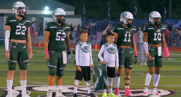 Two of Wyatt Brey’s teammates joined the Canton captains at midfield for the coin toss before Friday night’s game against the visiting Van Vandals. Photo by Cori Smith