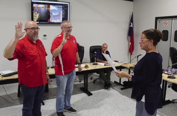The oath of office was administered to incumbent Van City Council members Mark Heatwole (far left), Linzy Neal, and Charles Ryan during the regular monthly council meeting June 8. Ryan participated in the swearing-in ceremony through ZOOM. Administering the oath of office was City of Van Secretary Sereca Huggins. The three incumbents were the only candidates that filed for the May 6 city election which eventually was cancelled. Photo by David Barber