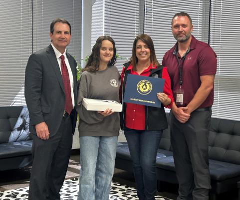 Van Junior High School student Landry Davis (second from left) was recognized for her academic success as she was named to the Superintendent’s Committee by District 2 State Representative Jill Dutton. A flag was flown in the student’s honor over the Texas Capitol Oct. 9. Standing with the student were left to right, Van ISD Superintendent Don Dunn, Dutton, and VJH Principal Jeremy Whitten. Courtesy photo