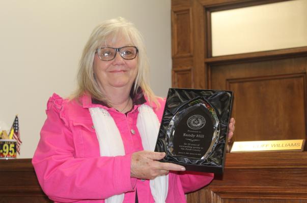 An ‘Outstanding Service Award’ was presented to retiring Van Zandt County Auditor Sandy Hill Jan. 24 for her 30 years of service to VZC, including the last seven years as VZC auditor. The award was presented by VZC District Judge Chris Martin during a special called meeting of the VZC Commissioners Court. Photos by David Barber