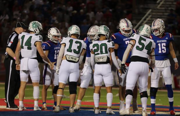 Captains for the Canton Eagles (white uniforms) and the Bullard Panthers met at the center of the field for the opening coin toss prior to their Oct. 13 District 8-4A, Division 2, contest at Bullard. Representing the Eagles were left to right, Justus Petree (14), Jesse Hipp (13), Collin Campuzano (20), and Jonathan Berry (54). The Eagles lost a heartbreaking 28-21 decision to the Panthers. Photo by Lianna Reid
