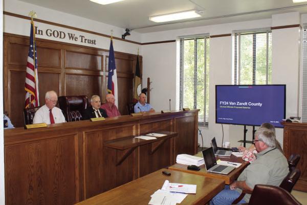 Van Zandt County Judge Andy Reese, second from left, discussed a proposal regarding fiscal year 2024 VZC Elected Officials’ Proposed Salaries through a power point presentation during the July 12 meeting of the VZC Commissioners Court. In a surprising result, Reese broke a 2-2 tie as he voted to deny the proposal. Photo by David Barber