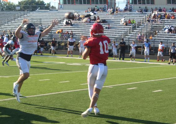Van Vandal quarterback Jaxon Moffatt (10) fires a sideline pass as a Grand Saline Indian defendermoves in to rush the QB. The two former Van Zandt County rivals faced off Aug. 17 in Grand Saline for their final pre-season tune-ups. Photo by David Barber