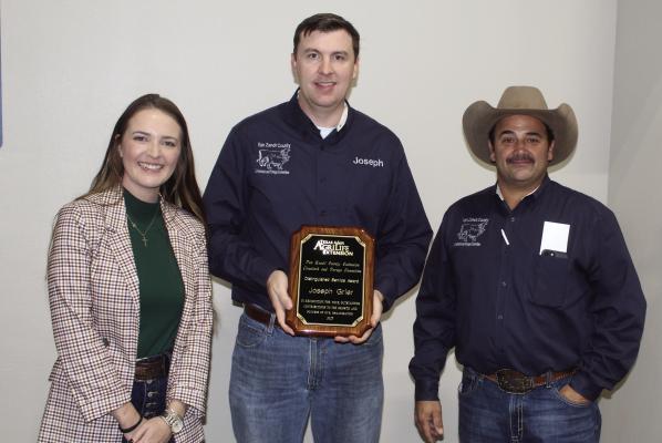 Joseph Grier, center, was recognized with a ‘Distinguished Service Award’ Nov. 2 during the annual Van Zandt County Hay Evaluation Clinic and Auction at the VZC Farm Bureau building in Canton. The award was presented by Allison Morrow from the VZC Texas A&amp;M AgriLife Extension Service office and Gregg Beverly from the VZC Livestock/Forage Committee. Photo by David Barber