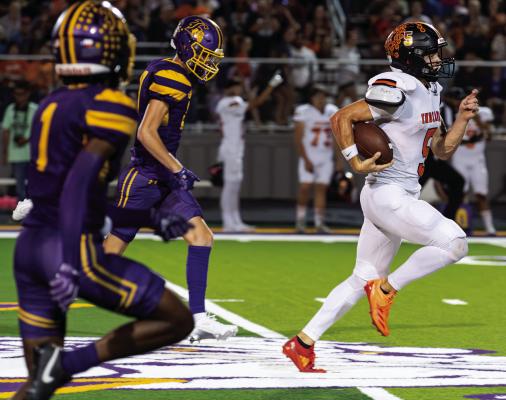 Grand Saline Indian junior quarterback Jett Taylor (white uniform) outraces two Edgewood Bulldog defenders to the end zone Oct. 11 during their Van Zandt County rivalry game. Taylor had a spectacular individual performance as he scored seven touchdowns in Grand Saline’s 75-40 victory to remain undefeated at 6-0. Photo by Dusty Goodwin