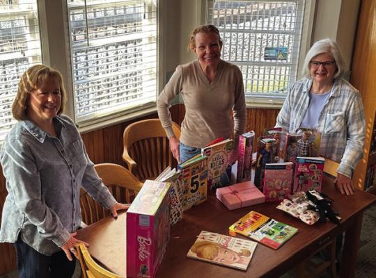 Grand Saline Friends of the Library Vice-President Yvonne Trent (left) and President Catrennia Williamson (right) deliver a donation of Barbie dolls and Legos. The Grand Saline Library hosts Barbie Free Play on Mondays and Lego Lab on Wednesdays. Both events are open to the public. Librarian Brandi Simpson (center) takes delivery of the donation. Courtesy photo