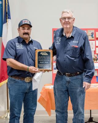 Butch Grier, at right, was presented the Distinguished Service Award from Gregg Beverly during the Van Zandt County Hay Evaluation Dinner and Auction at the VZC Farm Bureau Event Center in Canton Nov. 3. Photo by Faith Caughron