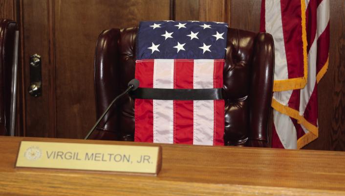 In memory of Van Zandt County Pct. 2 Commissioner Virgil Melton Jr., an American flag was placed over his chair in the commissioners’ courtroom prior to the beginning of the June 5 regular meeting of the commissioners’ court. Photo by David Barber