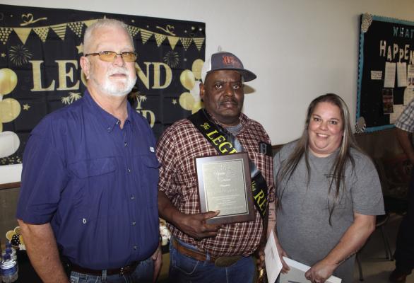 John Bowman received an appreciation plaque for his 34 years of service in maintenance at the Van Zandt County Courthouse. Presenting the plaque were Van Zandt County Maintenance Manager Cris Burnett and VZC maintenance employee Erin Walker. Photo by David Barber