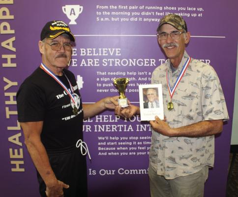 Tony Barber of Fort Worth, right, the son of the late Liston Barber of Martins Mill, received a trophy and medal from ‘The Old Timers Club’ Promoter David Marlowe during a special recognition held in memory of their oldest club member April 12 at Anytime Fitness in Canton. Photo by David Barber