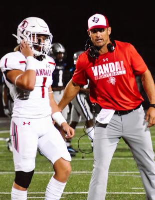Cannon Rainey (1) receives instructions from a member of the Van Vandal coaching staff Sept. 16 during action against the Paris Wildcats. Van took a 2-2 overall record into their District 8-4A, Division 2, contest at home against the Brownsboro Bears Sept. 23. Photo by Liz Hinch