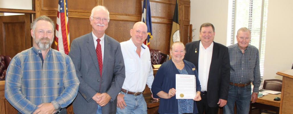 Carrie Woolverton of the Van Zandt County Historical Commission stood with the VZC Commissioners Court following unanimous approval by the court to recognize June 14 as Flag Day and the week of June 12 as Flag Week. Standing with Woolverton were left to right, VZC Pct. 1 Commissioner Chad LaPrade, VZC Pct. 2 Commissioner Virgil Melton Jr., VZC Pct. 3 Commissioner Keith Pearson, VZC Judge Don Kirkpatrick, and VZC Pct. 4 Commissioner Tim West. Photo by David Barber