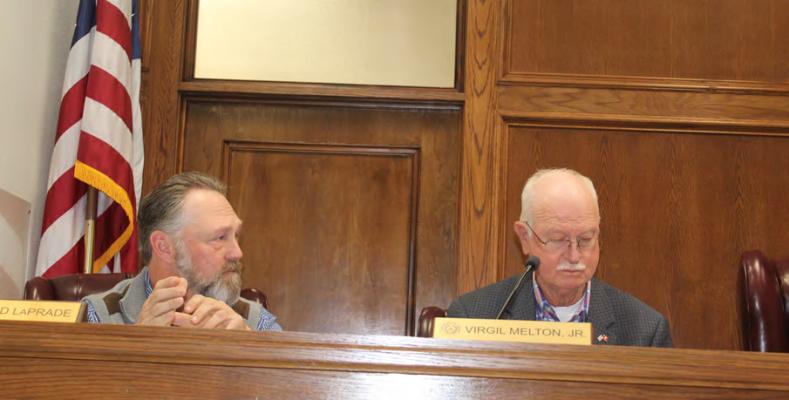 Van Zandt County Pct. 1 Commissioner Chad LaPrade (left) responds to a question about funding communication tower land and lease contracts from American Rescue Plan (ARP) interest funds March 21 during a special called meeting of the VZC Commissioners Court. Looking over the paperwork is VZC Pct. 2 Commissioner Virgil Melton Jr. Photo by David Barber