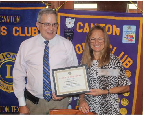At the conclusion of the regular weekly luncheon meeting of the Canton Lions Club July 19 at the Van Zandt Country Club, Van Zandt County Judge and Canton Lions Club member Andy Reese was presented a ‘Certificate of Appreciation’ from Canton Lions Club Vice-President Tonda Curry. Reese was the guest speaker at the luncheon on his 200th day in office as VZC judge. Photo by David Barber