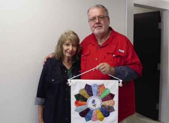 Texas Star Quilters Guild, Van Zandt County, Publicist Janet Bragdon presented a 2025 TSQG Sponsor Quilt recently to Van Zandt Newspapers LLC Editor David Barber. The annual TSQG event was held Nov. 7, 8 at the Parish Hall at St. Therese Catholic Church in Canton. Barber served as one of the quilt judges for the event. Photo by Tim Ball