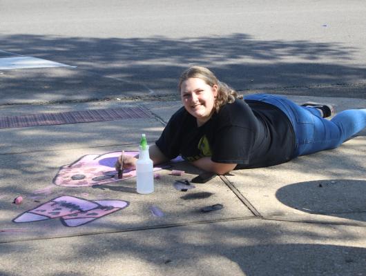 Serenity Allison, a Canton High School art student, created some sidewalk art on the Van Zandt County Courthouse grounds prior to the Oct. 12 Main Street Autumn Festival in downtown Canton. The 23rd annual festival is a major fund-raising family-friendly event for the Canton Main Street program. Photo by Susan Harris