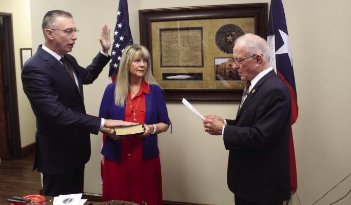 The Oath of Office was administered June 19 to new Van Zandt County Republican Party Chairman Tom Duke (left) as his wife, Suzanne, holds the Bible. Duke was administered the Oath of Office by Texas District 2 State Senator Bob Hall. The swearing-in ceremony was held in Hall’s Canton office. Photos by David Barber