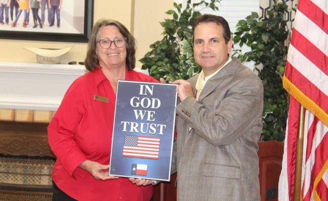 Edom Mayor and Republican Women of Van Zandt County member Barbara Crow presented ‘In God We Trust’ framed posters to Van ISD Superintendent Don Dunn Oct. 17 during the regular monthly meeting of the Van School Board. Photo by David Barber