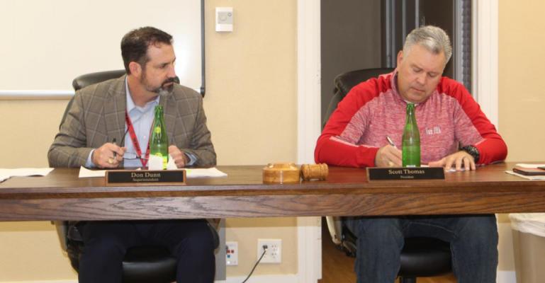 Van ISD Superintendent Don Dunn (left) goes over his monthly superintendent’s update as Van School Board President Scott Thomas takes notes Feb. 21 during the regular monthly meeting of the Van School Board. Photo by David Barber