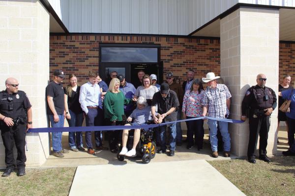 The ribbon-cutting ceremony for the newly named Susan Pace Dining Hall at the Wills Point Middle School was held March 5 as Mrs. Pace cut the ribbon. A large number of school administrators, teachers, staff, former students, and family members were in attendance during the program inside the facility. Mrs. Pace died three days later following the dedication ceremony. Her funeral service was held March 13 at Wills Point High School. Photo by David Barber