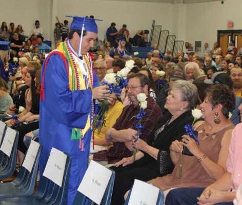 Fruitvale Class of 2022 Valedictorian Mason Smith presents roses to family members during graduation ceremonies June 3. Photo By Britne Hammons