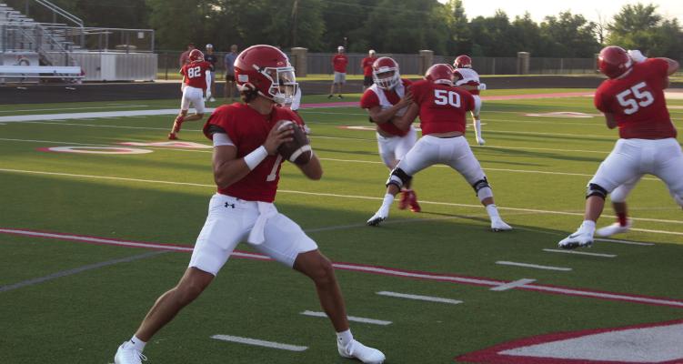 Van Vandal quarterback Rawly Hinch looks for a receiver downfield Aug. 8 during the Annual Red/White Inter Squad Scrimmage held at Van’s Memorial Stadium. Varsity football teams around Van Zandt County are in the middle of their pre-season scrimmage schedule as they continue preparations for the start of the 2025 regular season Friday, Aug. 29. Photo by David Barber