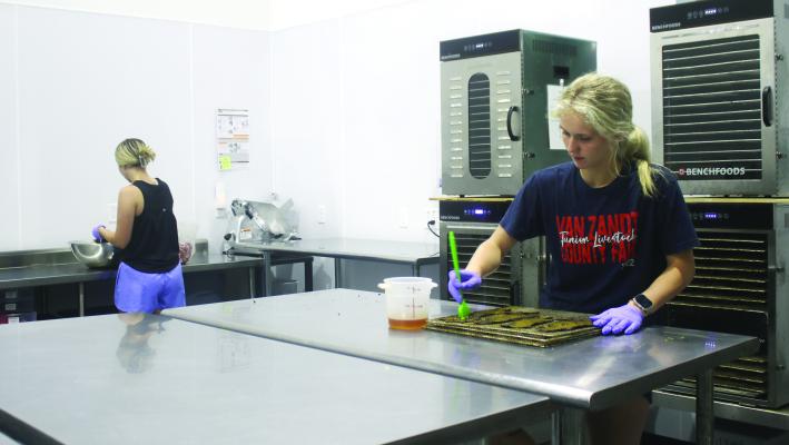 East Texas Jerky employees Ashlynn Swallow (left) and MaKenna Swallow prepare an order for a customer during a busy day at the business in Edgewood. The business opened its doors in 2017. Photo by Susan Harris
