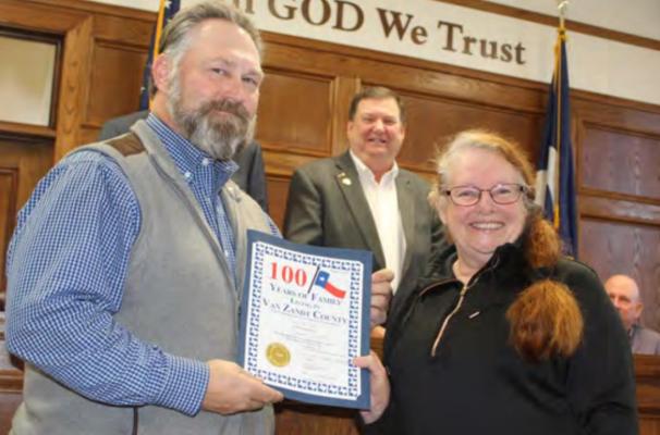 Van Zandt County Pct. 1 Commissioner Chad LaPrade (far left) received a ‘100 Years of Family Living in VZC’ commemorative certificate from VZC Genealogical Society President Carrie Anne Wilson-Woolverton. Also shown is VZC Judge Don Kirkpatrick. Photo by David Barber
