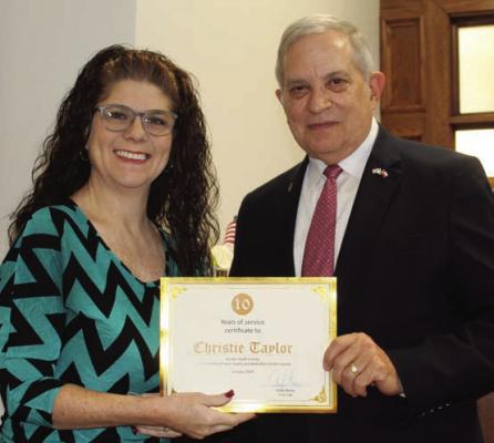 Van Zandt County Court Administrator Christie Taylor was recognized for her 10 years of service to VZC Jan. 31 during the regular meeting of the VZC Commissioners Court. Presenting her with a ‘Certificate of Appreciation’ is VZC Judge Andy Reese. Photo by David Barber