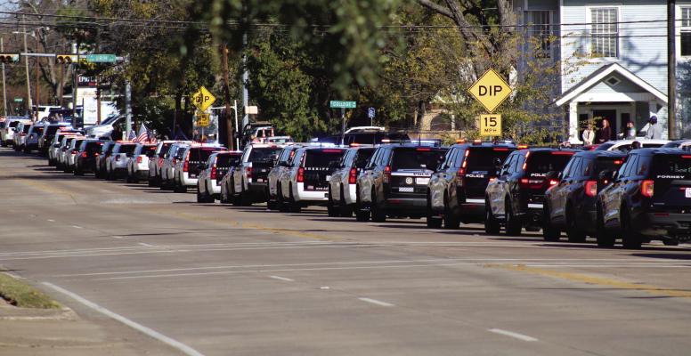 Citizens, visitors, police, and many others lined the streets of North Rockwall Avenue off U.S. Highway 80/Moore Street in Terrell for the procession of fallen Terrell Police Officer Jacob Candanoza on Wednesday, Dec. 11. Photo by Bodey Cooper