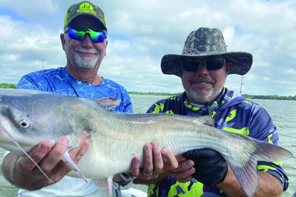 Jeff Rice, left, and Tawakoni catfish guide Tony Pennebaker show off one of many good eating blue catfish landed last week. Photo by Luke Clayton