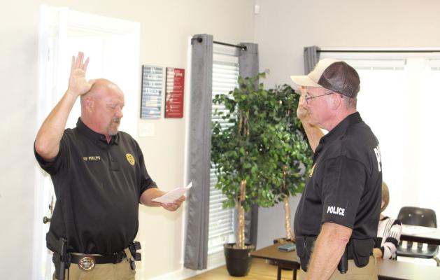 Van ISD Police Officer Sean Waterman (right) was sworn in for duty by Van ISD Director of Public Safety Odie Phillips Aug. 18 during the regular monthly meeting of the Van School Board. Photos by David Barber