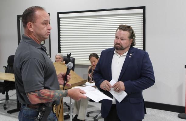 Gene Keenon of Republic Services (right) presented an annual donation check totaling $1,000.00 to the Van Volunteer Fire Department July 19 during the regular monthly meeting of the Van City Council. Accepting the check is City of Van Fire Marshal/Police Jeff Hudgens. Photo by David Barber