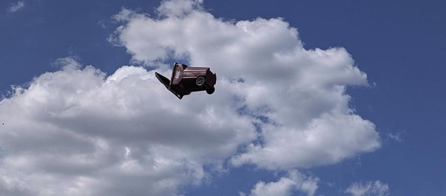 On Monday afternoon a whirlwind or dust devil traveled along West Tyler St. in Canton, lifting trash bins and debris thirty to fifty feet in the air. The sudden burst of rotating air also damaged a building as it peeled off trim from the edge of the roof. Photo from Brian Edwards