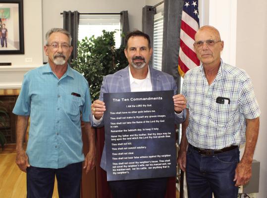Copies of the Ten Commandments were presented by the Republican Club of Van Zandt County at every school board meeting in VZC during the month of August. One of the presentations occurred in Van ISD where Van ISD Superintendent Don Dunn (middle) received a printed copy from Republican Club of VZC President Doc Collins (right) and Republican Club of VZC Member Frank Gay. Photo by David Barber