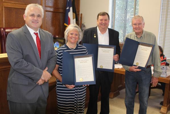 The offices of State Representative Bryan Slaton and State Senator Bob Hall presented retirement resolutions to three retiring Van Zandt County elected officials during the Nov. 9 regular meeting of the VZC Commissioners Court. Shown were left to right, Slaton, VZC Pct. 2 Justice of the Peace Sandra Plaster, VZC Judge Don Kirkpatrick and VZC Pct. 4 Commissioner Tim West. Hall was not in attendance. Photo by David Barber
