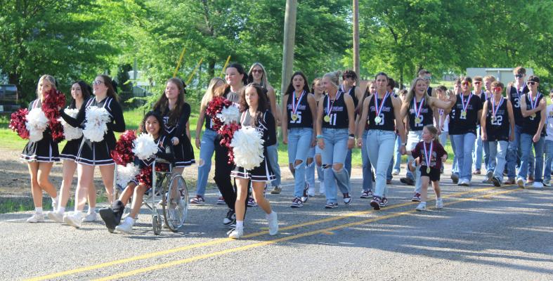 Members of the cheerleading squad along with the Martins Mill Lady Mustangs and Mustangs’ varsity basketball teams participated in a parade walk April 10 from the Martins Mill Store to the O’Neal Weaver Gymnasium to celebrate the teams’ Class 2A, Division 2, State Basketball Championships. Following the parade, a rally for the teams was held in the gymnasium. Photo by David Barber