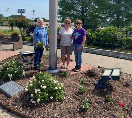 Jimmie Pierce, Paula Marshal and Lee Anne Reisner have volunteered their time and energy towards planting flowers around the flagpole at the Van Zandt County Veterans Memorial in preparation for the upcoming Memorial Day Ceremony scheduled to take place May 29. Courtesy photo
