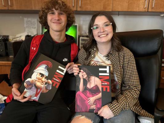 Van High School Photo Editor Bradley White and VHS Yearbook Editor Jillian Veader display copies of the 2023-24 Vandalite yearbook that have recently arrived on campus. The theme of the yearbook is ‘Me in Time.’ The yearbook includes a personal photo on each cover, a handwritten letter from the student, and a special QR code on the back cover. Photo courtesy of the Van High School Journalism Department