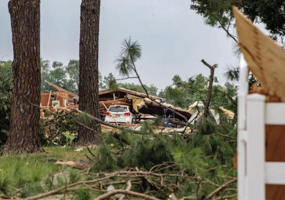 A dangerous storm system made its way across East Texas June 15-16, uprooting trees, damaging roofs and vehicles and snapping power poles. Despite the widespread damage cleanup efforts began almost immediately as hundreds of volunteers sprang into action to help their neighbors in need. Photo by Faith Caughron