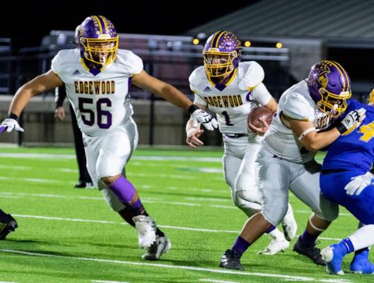 The Edgewood line, including junior tackle Maverick Segovia (56), help to clear a running lane for quarterback Hayden Wilcoxson during bi-district round play. Photo by Dusty Goodwin