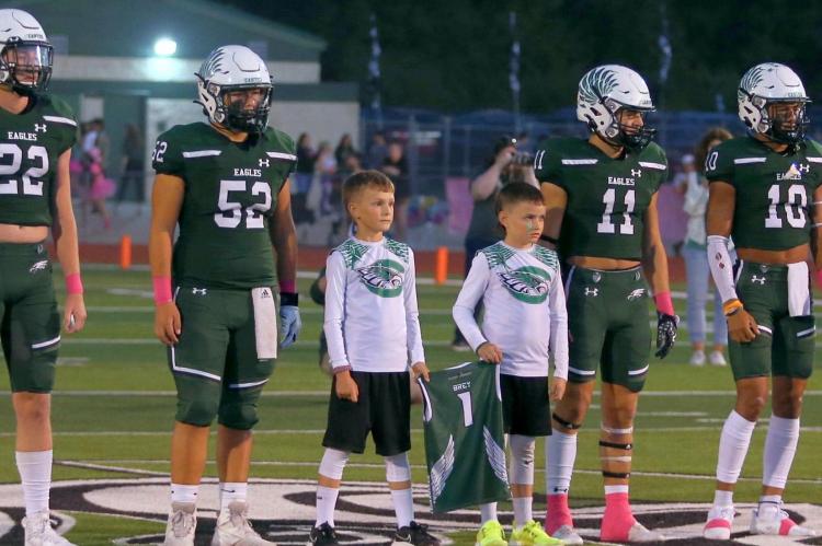Two of Wyatt Brey’s teammates joined the Canton captains at midfield for the coin toss before Friday night’s game against the visiting Van Vandals. Photo by Cori Smith