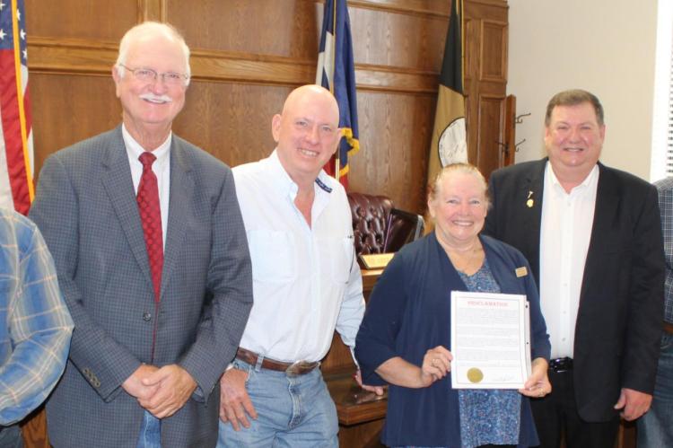 Carrie Woolverton of the Van Zandt County Historical Commission stood with the VZC Commissioners Court following unanimous approval by the court to recognize June 14 as Flag Day and the week of June 12 as Flag Week. Standing with Woolverton were left to right, VZC Pct. 1 Commissioner Chad LaPrade, VZC Pct. 2 Commissioner Virgil Melton Jr., VZC Pct. 3 Commissioner Keith Pearson, VZC Judge Don Kirkpatrick, and VZC Pct. 4 Commissioner Tim West. Photo by David Barber